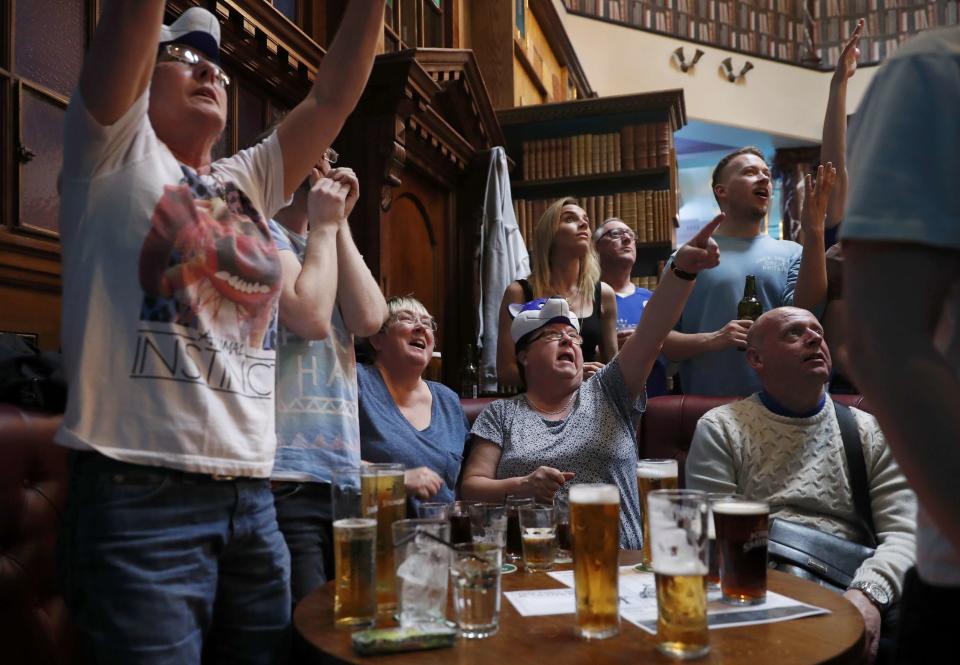 Leicester City fans react during their team's soccer match against Manchester United, as they watch the match on television in the Hogarth's pub in Leicester, Britain May 1, 2016 REUTERS/Eddie Keogh