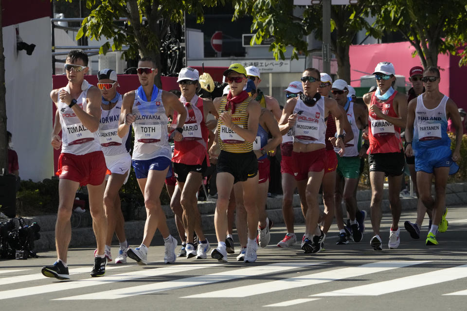 Athletes led by Dawid Tomala, of Poland, compete during the men's 50km race walk at the 2020 Summer Olympics, Friday, Aug. 6, 2021, in Sapporo, Japan. (AP Photo/Eugene Hoshiko)