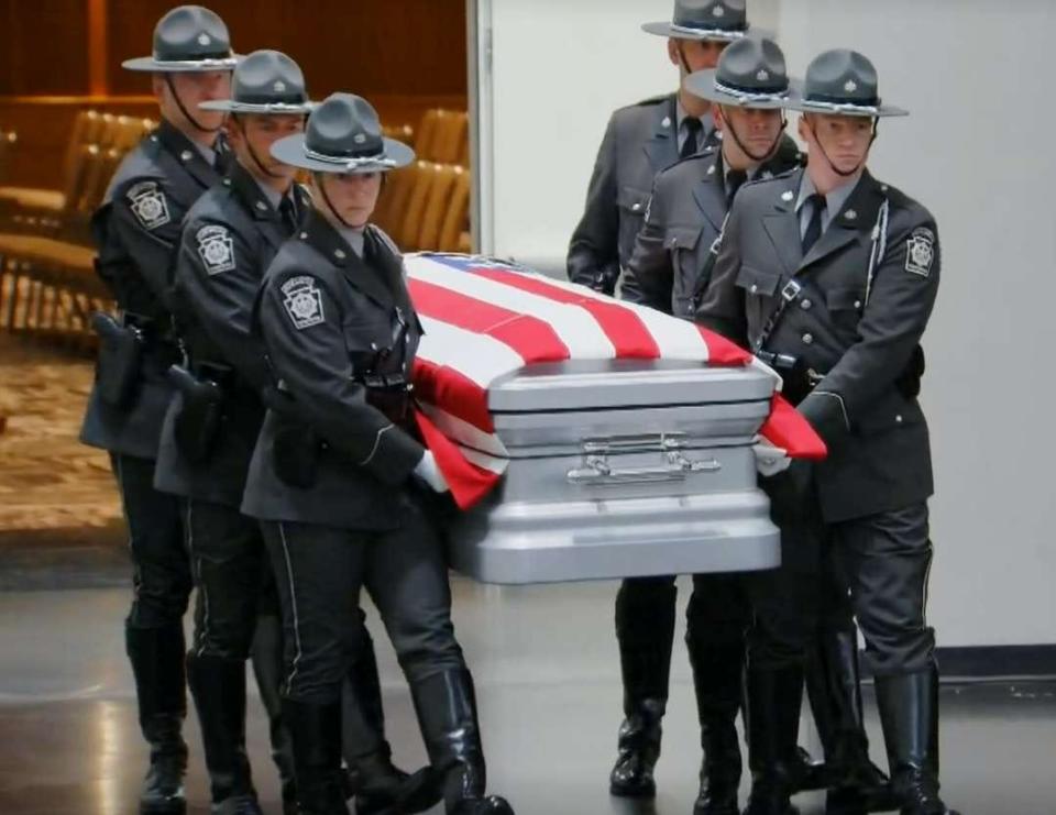 Pennsylvania State Troopers bring in the casket of Jacques Rougeau Jr. during funeral services for the fallen Trooper held June 27, 2023, at the Erie Bayfront Convention Center.