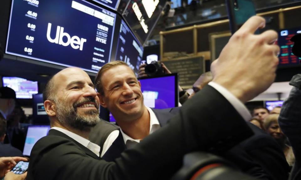 Uber’s CEO, Dara Khosrowshahi, left, and Ryan Graves, a now-departed board member, pose for a photo before the company lists during its initial public offering at the New York Stock Exchange in 2019.