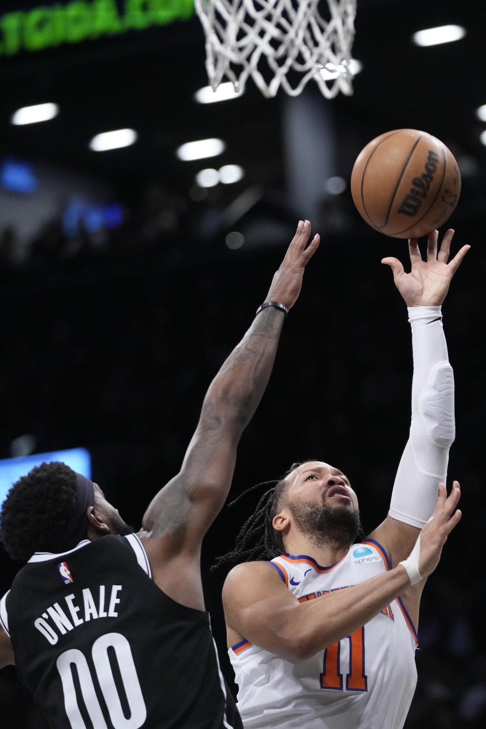 New York Knicks guard Jalen Brunson (11) goes to the basket against Brooklyn Nets forward Royce O'Neale (00) during the first half of an NBA basketball game Tuesday, Jan. 23, 2024, in New York. (AP Photo/Mary Altaffer)