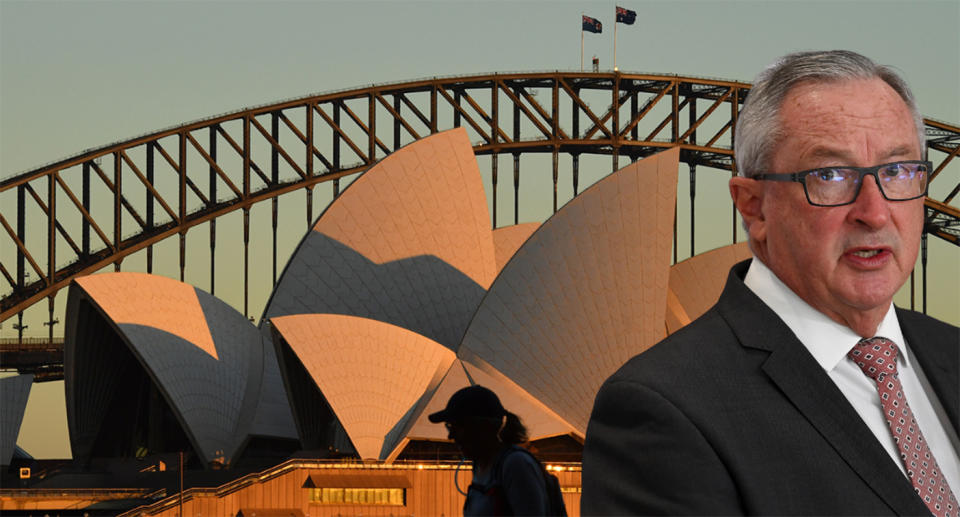 Brad Hazzard is pictured with a photo of the Sydney Opera House.