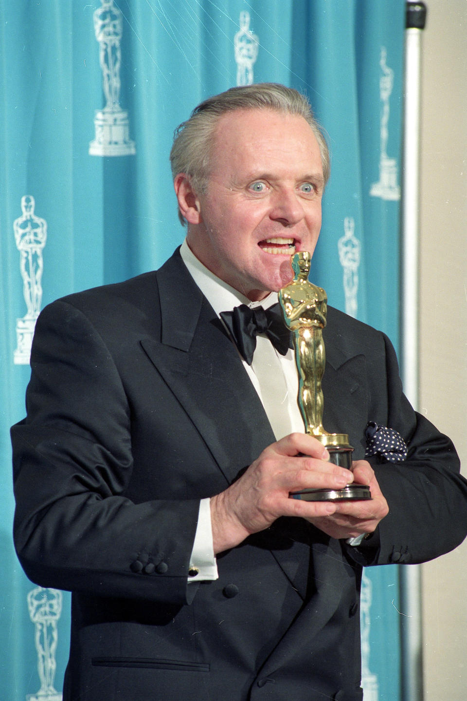 Actor Anthony Hopkins pretends to eat his Oscar Award backstage at the 64th Annual Academy Awards in Los Angeles, on Monday, March 30, 1992.  Hopkins won Best Actor honors for his portrayal of Dr. Hannibal Lecter in 