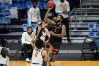 Oregon State forward Maurice Calloo (1) shoots over Oklahoma State guard Cade Cunningham (2) during the first half of a men's college basketball game in the second round of the NCAA tournament at Hinkle Fieldhouse in Indianapolis, Sunday, March 21, 2021. (AP Photo/Paul Sancya)