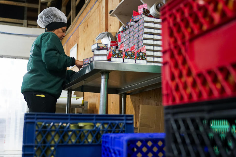 Angie Maldonado helps box tinned fish products for Los Angeles-based company Fishwife, Friday, Oct. 13, 2023, at a cannery in Bay Center, Wash. (AP Photo/Lindsey Wasson)