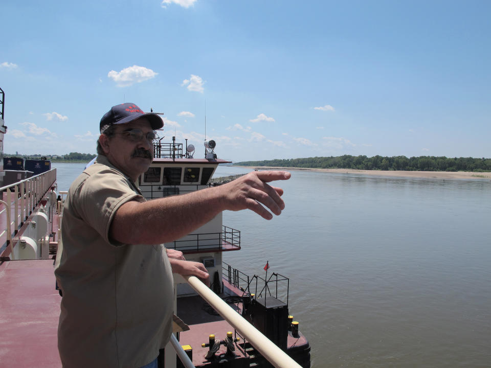 Frank Segree, captain of the U.S. Army Corps of Engineers' Dredge Hurley, points as he talks to reporters about dredging operations on the Mississippi River on Monday, Aug. 20, 2012 near Memphis, Tenn. The Mississippi River from Illinois to Louisiana has seen water levels plummet due to drought conditions in the past three months. Near Memphis, the river level was more than 12 feet lower than normal for this time of year. (AP Photo/Adrian Sainz)