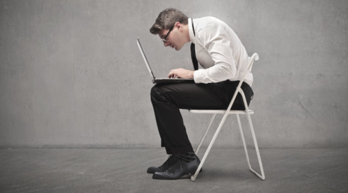 Man hunched over laptop