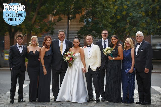 <p>Alfonso Lozano</p> Ciara Schirripa and Zach Binder pose with their families at their wedding.