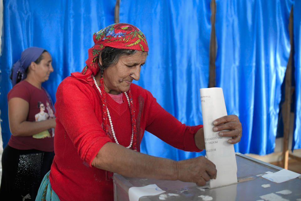 A woman casts her vote in Sintesti, Romania, Sunday, Nov. 10, 2019. Romania held a presidential election Sunday after a lackluster campaign that has been overshadowed by the country's political crisis, which saw a minority government installed just a few days ago.(AP Photo/Andreea Alexandru)