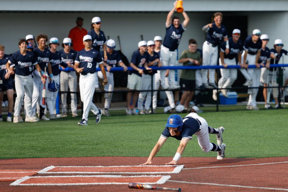 Olentangy Orange's Jacob Lattig slides home to score during a 6-1 win over Grove City on Friday in the Division I regional final.