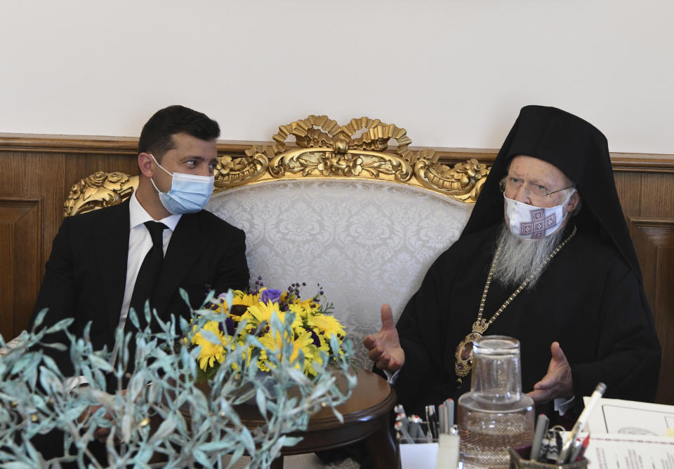 Ukrainian President Volodymyr Zelenskiy, left, wearing a mask to help protect from the spread of coronavirus, meets with Ecumenical Patriarch Bartholomew I, the spiritual leader of the world's Orthodox Christians, Friday, Oct. 16, 2020. (Nikolaos Manginas/Ecumenical Patriarchate Press Service, Pool via AP)