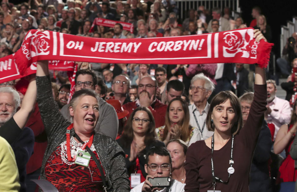 Delegates show their support for Britain's main opposition Labour Party leader Jeremy Corbyn, before his keynote speech at the Labour Party's annual conference in Liverpool, England, Wednesday Sept. 26, 2018. (Peter Byrne/PA via AP)