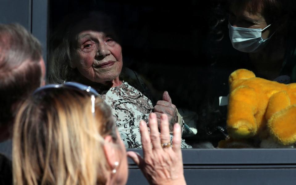 Martha Licoppe gestures to her family in Brussels - REUTERS