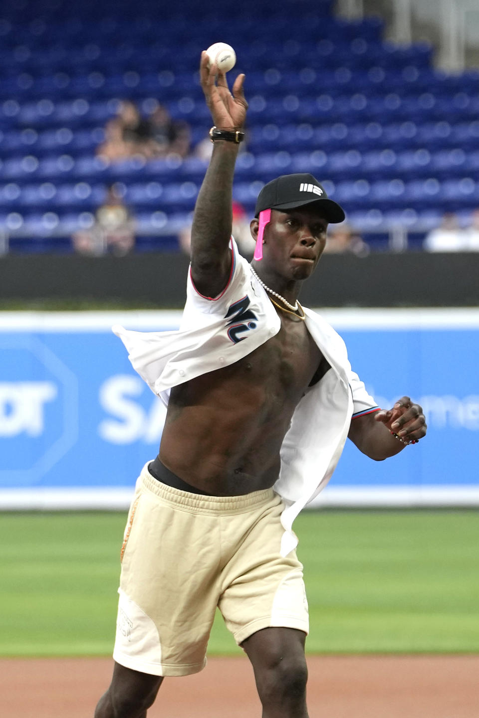 Mixed martial artist Israel Adesanya throws a ceremonial first pitch before a baseball game between the Miami Marlins and the Minnesota Twins, Monday, April 3, 2023, in Miami. (AP Photo/Lynne Sladky)