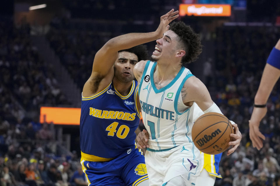 Charlotte Hornets guard LaMelo Ball (1) is fouled by Golden State Warriors forward Anthony Lamb during the first half of an NBA basketball game in San Francisco, Tuesday, Dec. 27, 2022. (AP Photo/Godofredo A. Vásquez)