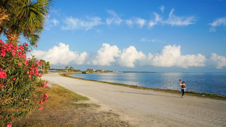 A woman jogging in the morning at Dunedin Causeway, Dunedin, Florida, April 23rd, 2017.