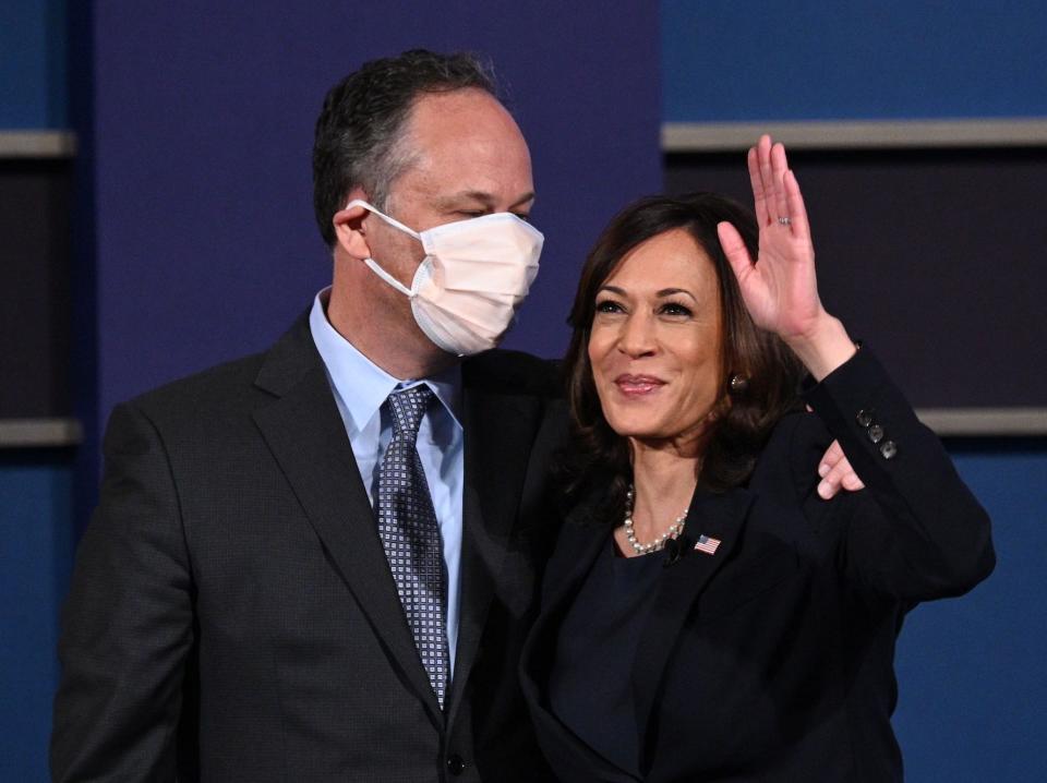 US Democratic vice presidential nominee and Senator from California, Kamala Harris (R) and husband Doug Emhoff stand onstage after the vice presidential debate in Kingsbury Hall at the University of Utah on October 7, 2020, in Salt Lake City, Utah. (Photo by Robyn Beck / AFP) (Photo by ROBYN BECK/AFP via Getty Images)
