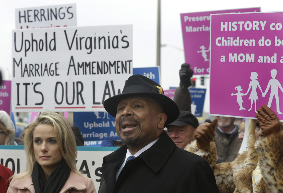 Former Republican lieutenant governor candidate E.W. Jackson, front center, speaks to the media during a demonstration outside Federal Court in Norfolk, Va., Tuesday, Feb. 4, 2014. Jackson spoke in favor of the law banning same-sex marriage. A federal judge will hear arguments Tuesday on whether Virginia's ban on gay marriage is unconstitutional. The state's newly elected Democratic attorney general has already decided to side with the plaintiffs and will not defend the ban. (AP Photo/Steve Helber)