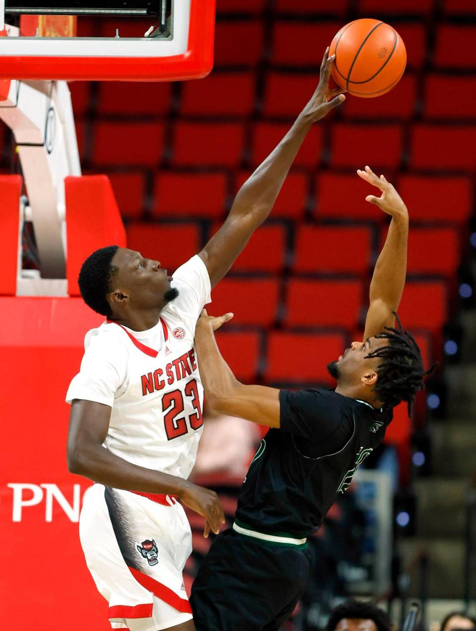 N.C. State’s Mohamed Diarra (23) blocks the shot by Mount Olive’s Brent Randleman (12) during the first half of N.C. State’s exhibition game against Mount Olive at PNC Arena in Raleigh, N.C., Wednesday, Nov. 1, 2023.