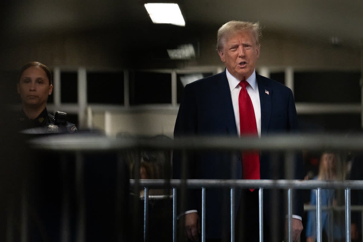 Donald Trump speaks to reporters before entering a criminal courtroom in Manhattan on 25 April (POOL/AFP via Getty Images)
