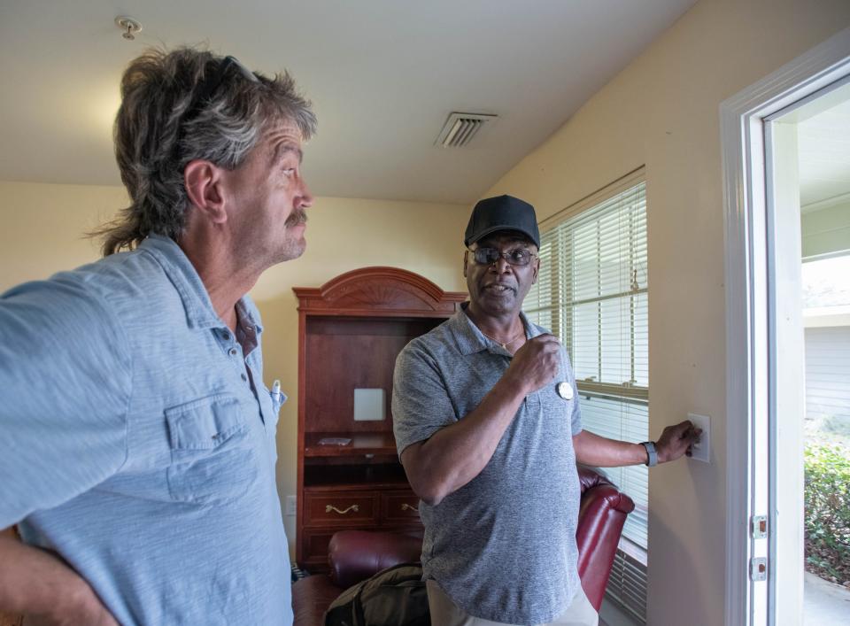 Program manager Roger Coleman, right, points out room features to new resident Richard Goble at the Volunteers of America Florida's Pensacola Veterans Village in Pensacola on Thursday, Dec. 8, 2022.  Goble, a Marine veteran, moved from the Waterfront Mission to his own studio apartment in the village earlier in the day.