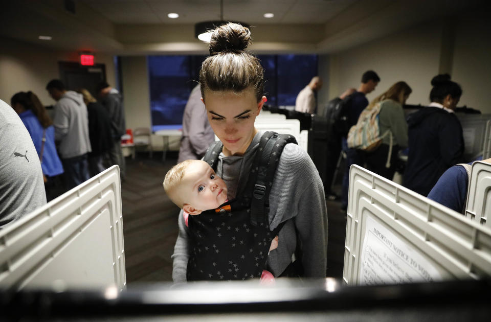 Kristen Leach votes with her six-month-old daughter, Nora, on election day in Atlanta, Tuesday, Nov. 6, 2018.&nbsp;