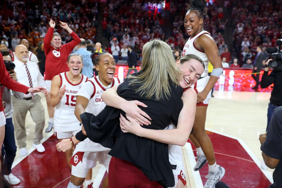 OU guard Payton Verhulst hugs coach Jennie Baranczyk in front of guard Lexy Keys, left, guard Nevaeh Tot, second from left, and forward Sahara Williams, right, after beating Texas 71-70 on Feb. 28 in Norman.