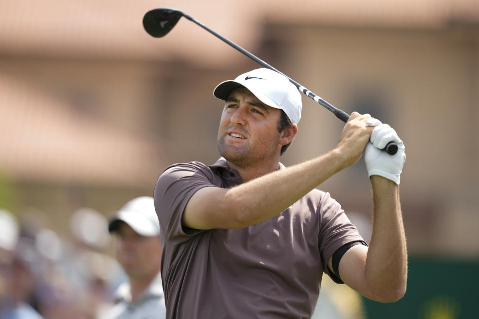 Scottie Scheffler watches his drive from the first tee during the second round of the Players Championship golf tournament Friday, March 10, 2023, in Ponte Vedra Beach, Fla. (AP Photo/Charlie Neibergall)