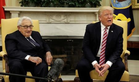 With former Secretary of State Henry Kissinger (L) at his side, U.S. President Donald Trump speaks to reporters after his meeting with Russian Foreign Minister Sergey Lavrov in the Oval Office of the White House in Washington, U.S., May 10, 2017. REUTERS/Kevin Lamarque
