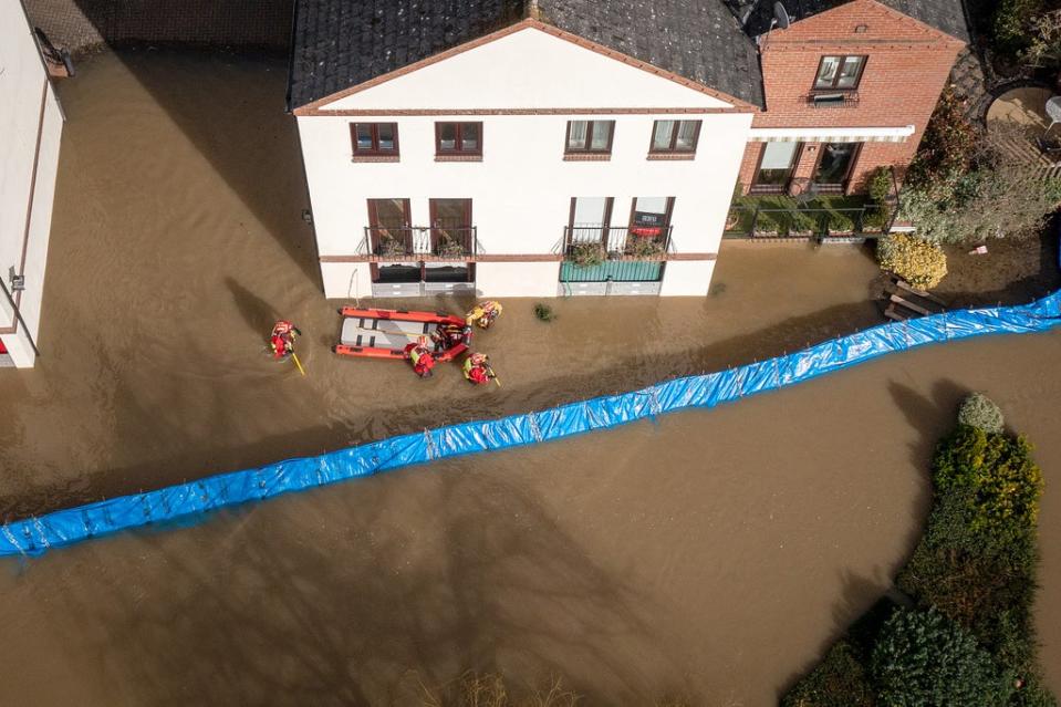 Rescuers wade through flood water in Bewdley to check on the welfare of residents after the River Severn breached defences on 23 February 2022 in Worcestershire (Getty Images)