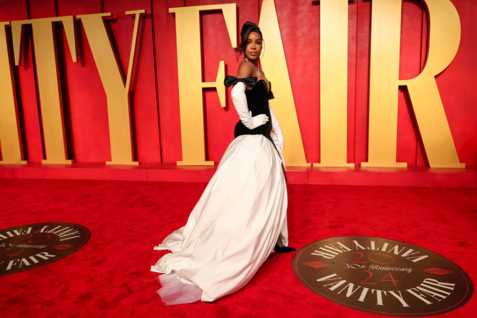 Laverne Cox in a white and black gown at the Vanity Fair event