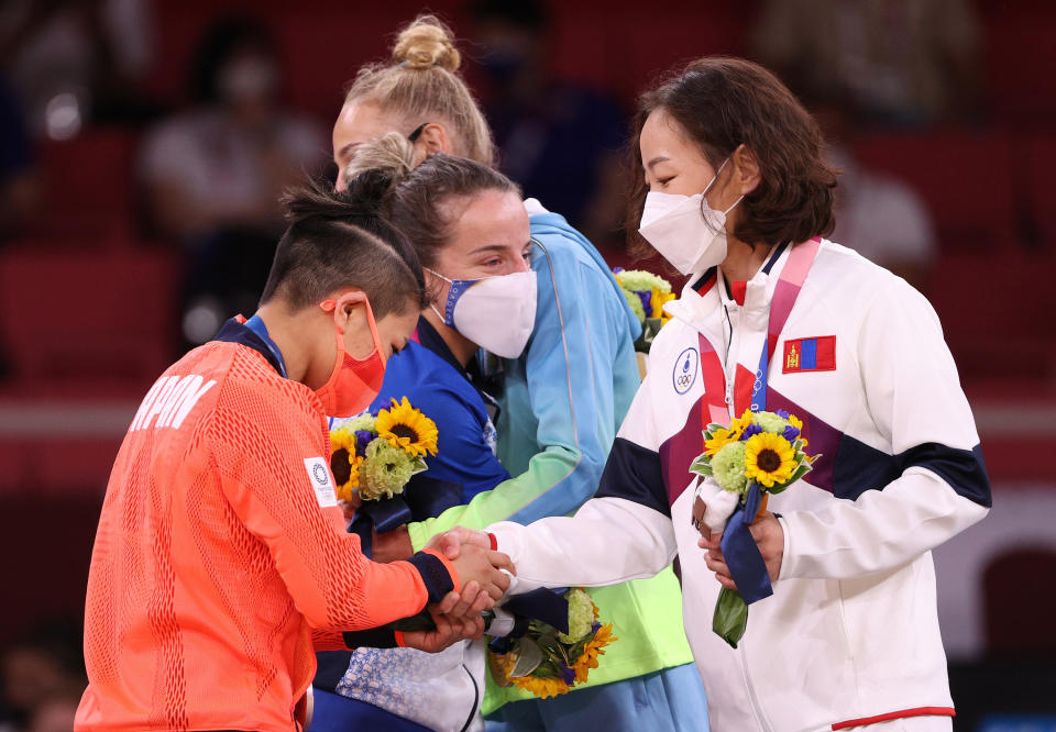 Urantsetseg Munkhbat of Team Mongolia shakes hands at award ceremony