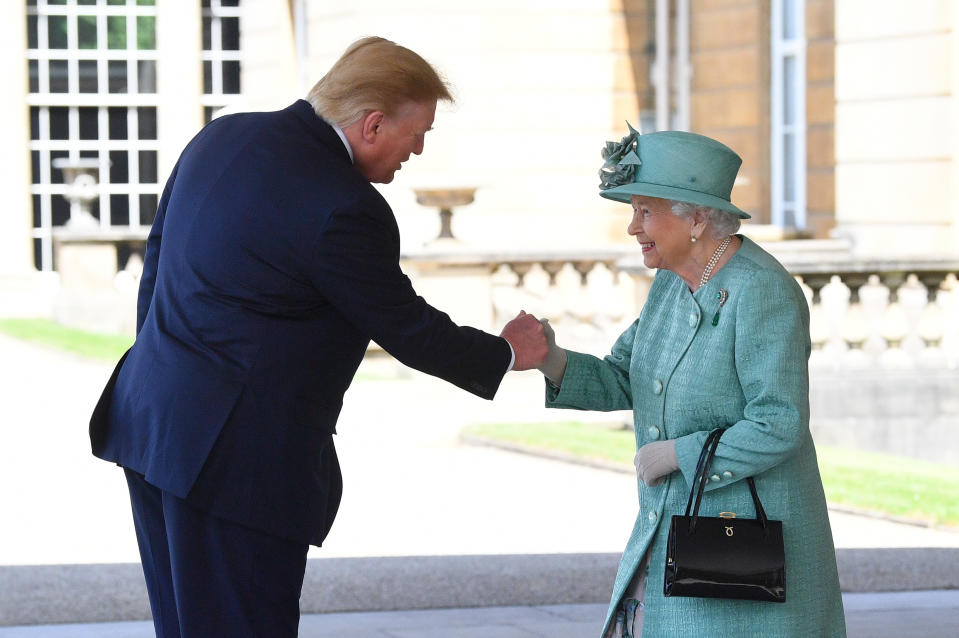 Queen Elizabeth II greets US President Donald Trump as he arrives for the Ceremonial Welcome at Buckingham Palace, London, on day one of his three day state visit to the UK.