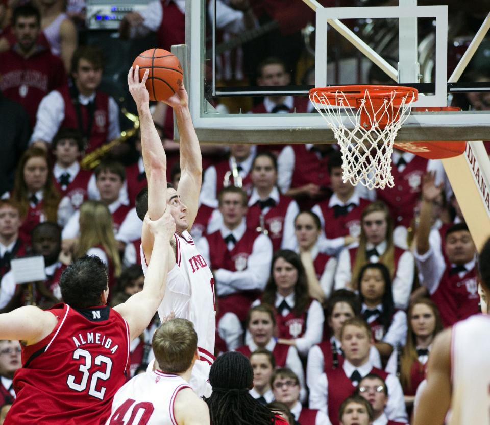 Indiana's Will Sheehey (0) is fouled by Nebraska's Andre Almeida (32) as he dunks the ball during the first half of an NCAA college basketball game, Wednesday, Feb. 13, 2013, in Bloomington, Ind. (AP Photo/Doug McSchooler)