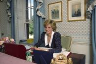 <p>The princess sits at her desk in the sitting room at Kensington Palace in 1985. </p>