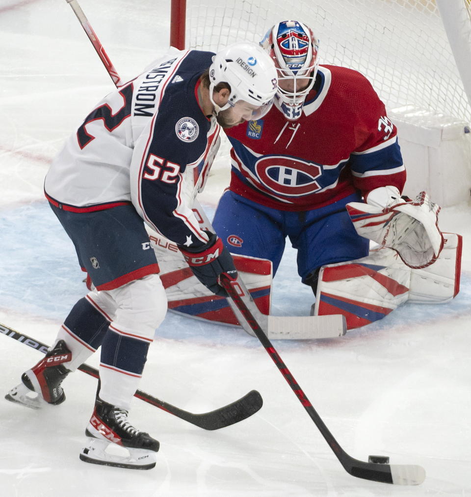 Columbus Blue Jackets right wing Emil Bemstrom (52) controls the puck in front of Montreal Canadiens goaltender Sam Montembeault (35) during the first period of an NHL hockey game Saturday, March 25, 2023, in Montreal. (Peter McCabe/The Canadian Press via AP)