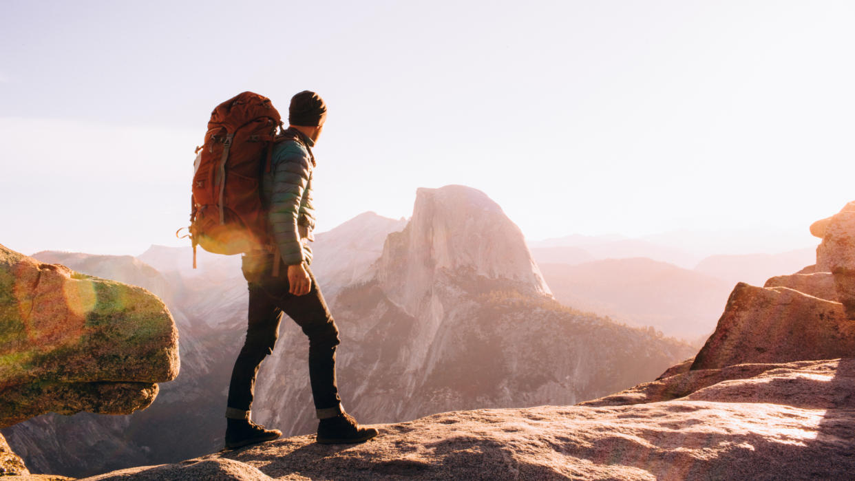  Hiker walking on mountain path, Yosemite, California. 