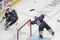 Arizona Coyotes' Taylor Hall (91) and Colorado Avalanche' Andre Burakovsky (95) look for the rebound from goalie Philipp Grubauer (31) during the second period of a first round NHL Stanley Cup playoff hockey series in Edmonton, Alberta, Friday, Aug. 14, 2020. (Jason Franson/The Canadian Press via AP)