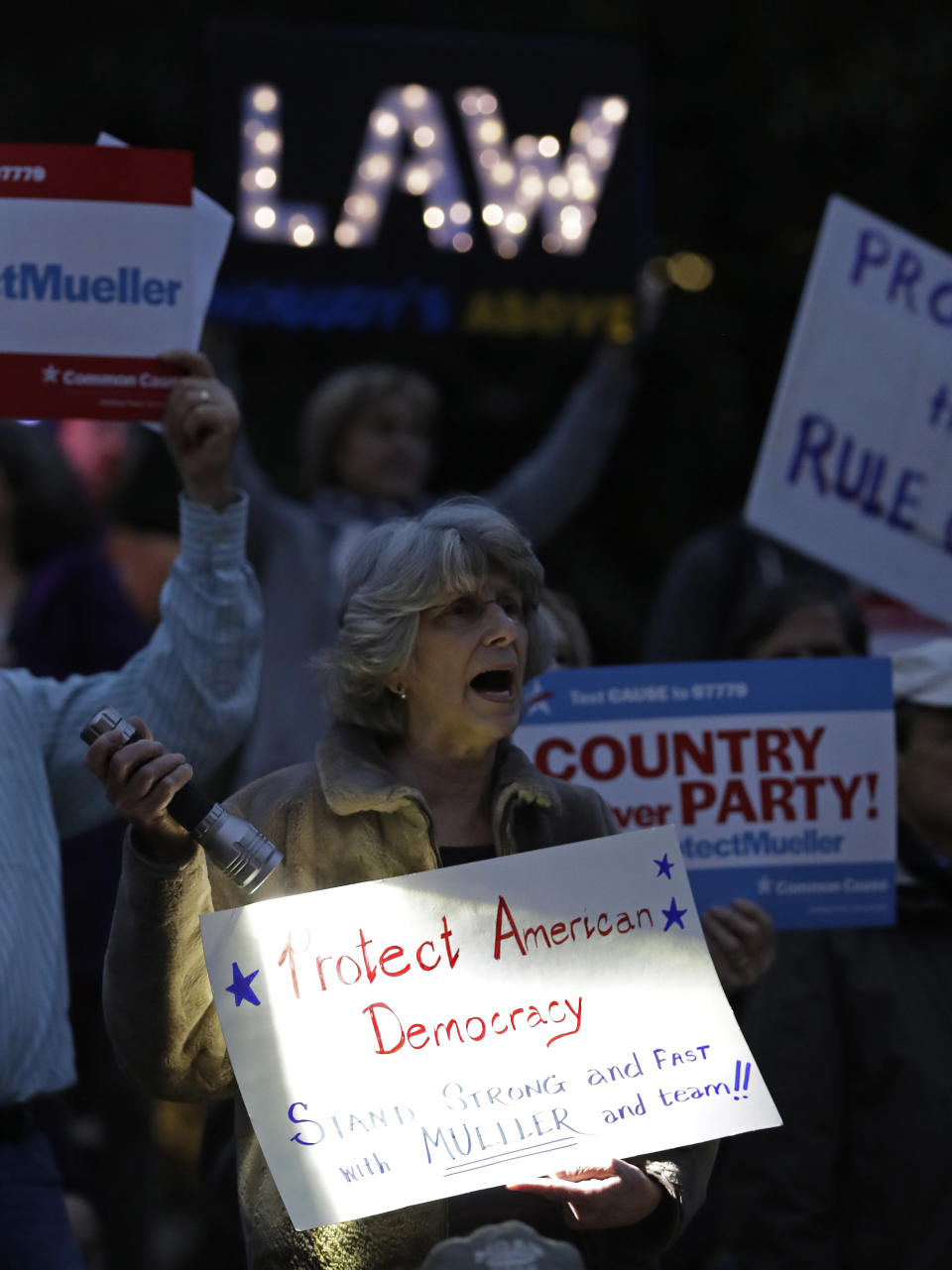 Protesters shout during a rally outside the Guilford County Courthouse against President Trump's Attorney General choice that could jeopardize the special counsel's work in Greensboro, N.C., Thursday, Nov. 8, 2018. (AP Photo/Chuck Burton)