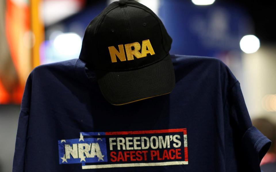 A cap and shirt are displayed at the booth for the National Rifle Association (NRA) at the Conservative Political Action Conference (CPAC) at National Harbor, Maryland - REUTERS