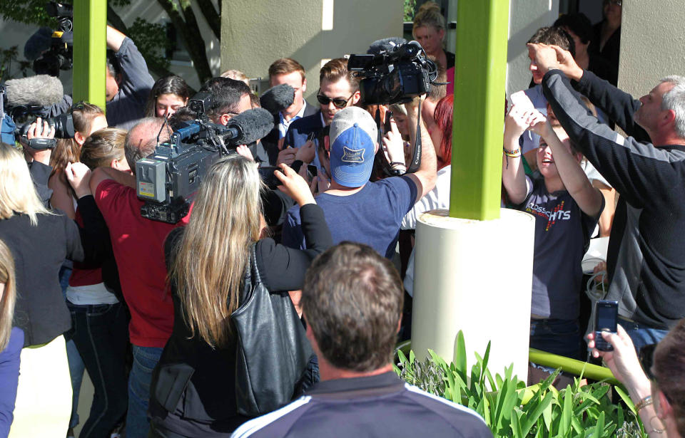 Hollywood actor Chris Pine, center top, is surrounded by people outside a courthouse in Ashburton, New Zealand, Monday, March 17, 2014. Pine, known for playing Captain Kirk in the "Star Trek" movies, pleaded guilty in the New Zealand court to drunken-driving charges. The 33-year-old was fined $93 New Zealand dollars ($79) and had his New Zealand driver’s license suspended for six months during a hearing at the Ashburton District Court. (AP Photo/Ashburton Guardian, Tetsuro Mitomo) NEW ZEALAND OUT, AUSTRALIA OUT, NO SALES