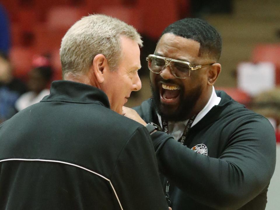 Buchtel asstistant coach Steve Culp (left) and head coach Rayshon Dent celebrate after a win over Gilmour Academy in a regional final, Saturday, March 11, 2023, in Canton.