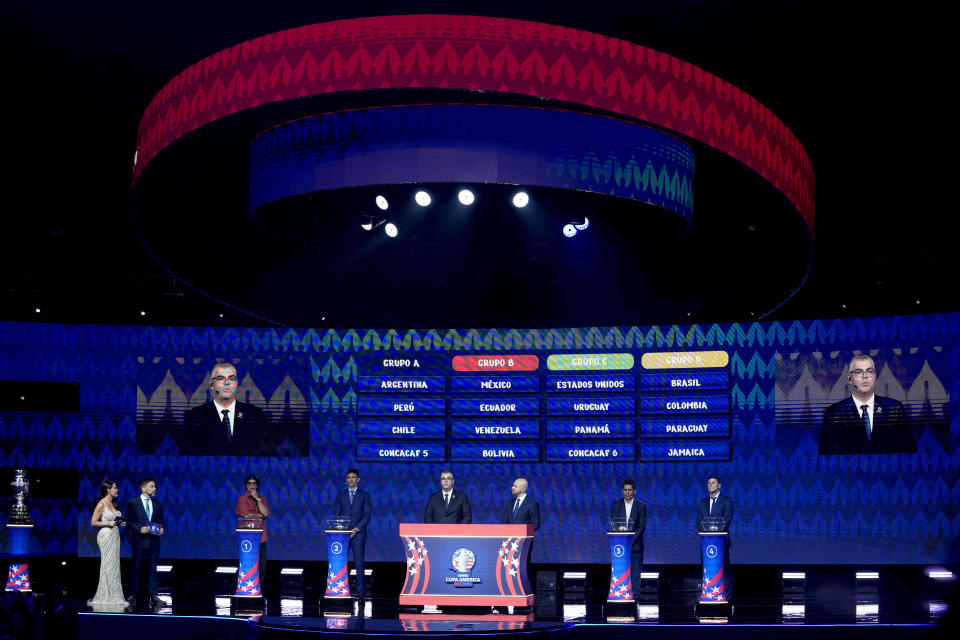 Brazil's Ronaldinho Gaucho, Paraguay's soccer player Roque Santa Cruz, Conmebol Competition Secretary Fred Nantes, Carlos Fernandez, Director of Competitions at CONCACAF, retired Mexican soccer goalkeeper and striker Jorge Campos and Javier Zanetti, former Argentine soccer player, from left to right, attend the draw ceremony for the Copa America soccer tournament, Thursday, Dec. 7, 2023, in Miami. The 16-nation tournament will be played in 14 U.S. cities starting with Argentina's opener in Atlanta on June 20, 2024. (AP Photo/Lynne Sladky)