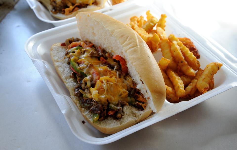 A cheesy Philly Cheesesteak sandwich and fries from Lee's Phillies and More truck on Friday, Jan. 28, 2023.