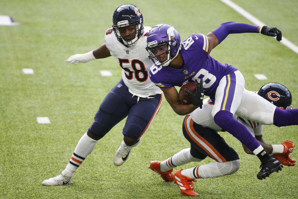 Minnesota Vikings wide receiver Justin Jefferson (18) is tackled by Chicago Bears linebacker Roquan Smith (58) and safety Eddie Jackson, right, after catching a pass during the first half of an NFL football game, Sunday, Dec. 20, 2020, in Minneapolis. (AP Photo/Bruce Kluckhohn)