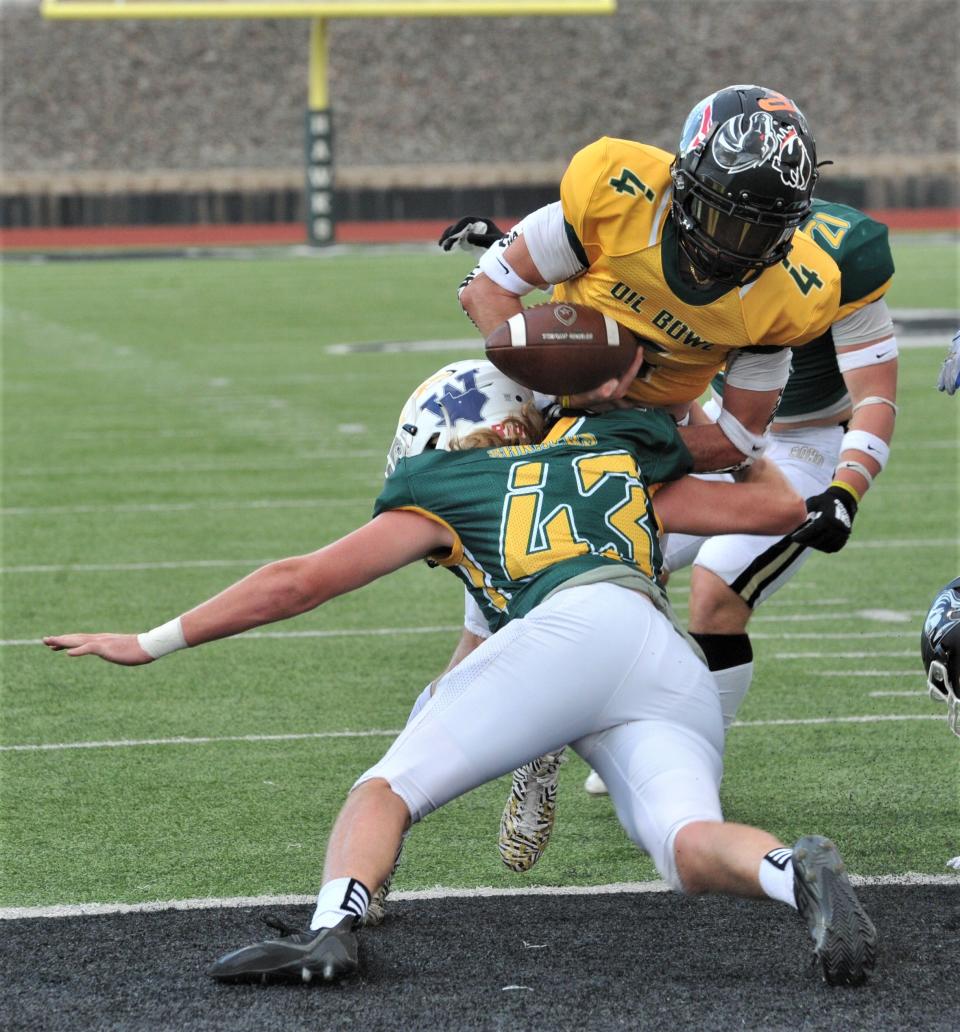 Hawley's Bradley Strickland tackles Henrietta's Braden Bell at the goal line during the 2022 Maskat Shrine Oil Bowl Football game at Iowa Park on Saturday, June 18, 2022.
