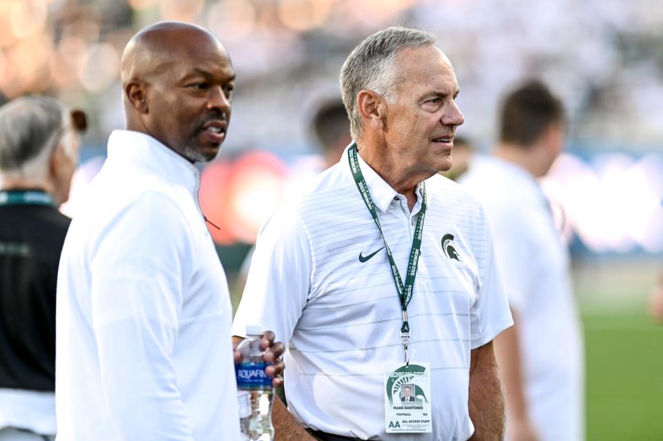 Former Michigan State football coach Mark Dantonio, right, and MSU Athletic Director Alan Haller mingle on the field before the football game against Central Michigan on Friday, Sept. 1, 2023, at Spartan Stadium in East Lansing.