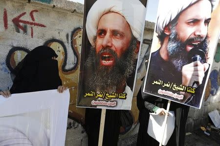 Shi'ite protesters carry posters of Sheikh Nimr al-Nimr during a demonstration outside the Saudi embassy in Sanaa October 18, 2014. REUTERS/Khaled Abdullah