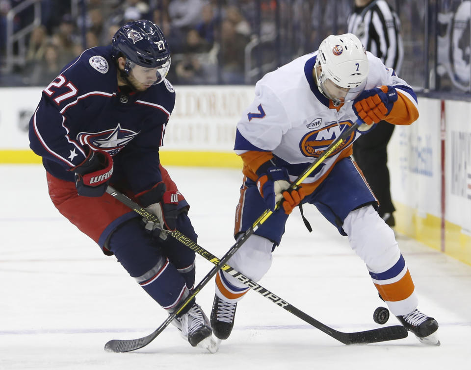 Columbus Blue Jackets' Ryan Murray, left, and New York Islanders' Jordan Eberle fight for the puck during the first period of an NHL hockey game Thursday, Feb. 14, 2019, in Columbus, Ohio. (AP Photo/Jay LaPrete)