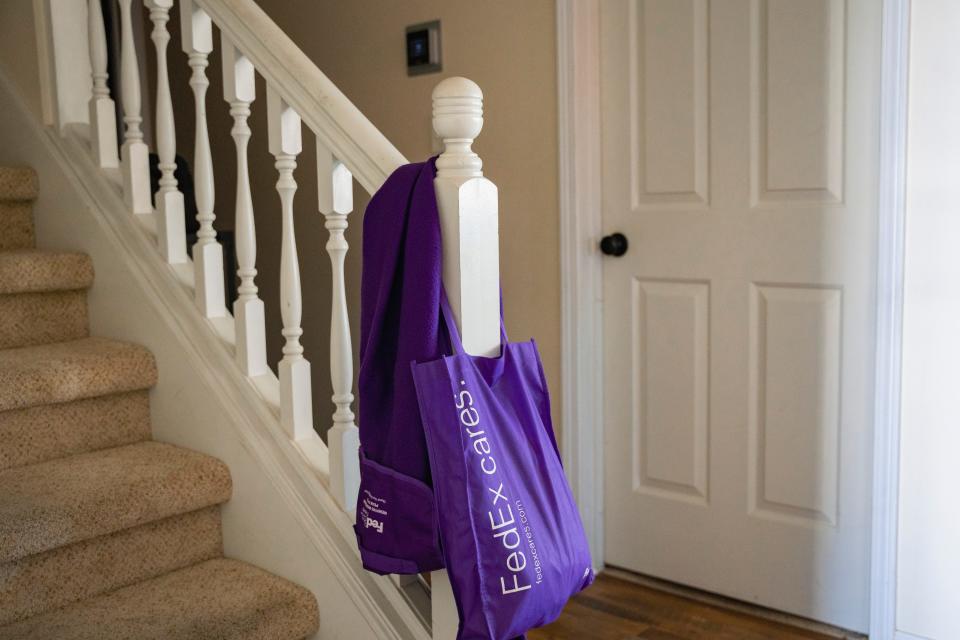 Back downstairs, James’ heavy work coat hangs on a rack just inside the front door. Draped over the banister is the purple tote bag James carried to work.